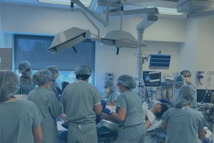 People wearing scrubs completing a surgical simulation