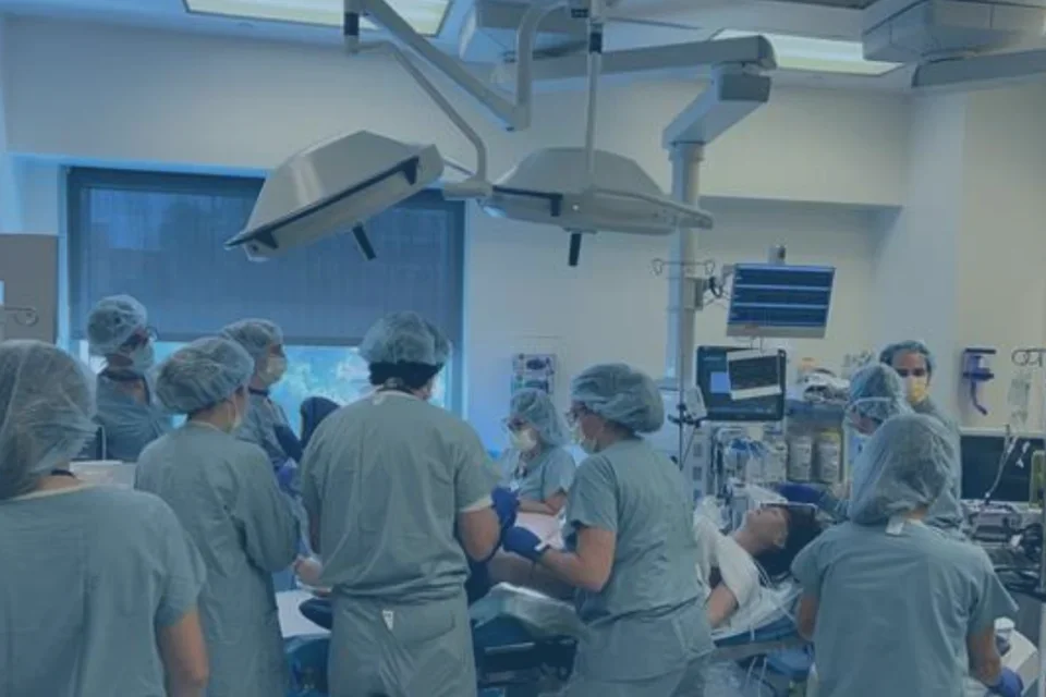 People wearing scrubs completing a surgical simulation